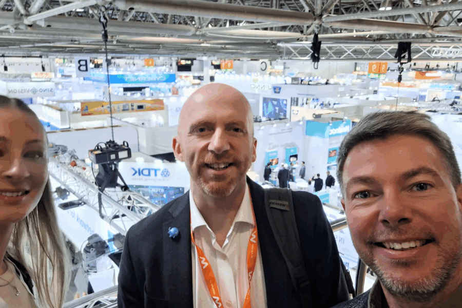 A team selfie at Medica 2025. With Lois, Iain and Lee all smiling at the camera.